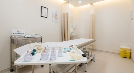 Sterile clinical hijama cupping therapy room with disposable medical equipment, single-use cups, clean white sanitization trays, and soft warm ambient clinic lights